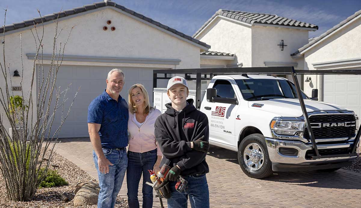 Happy Customers In Front of Their New Garage Doors