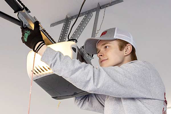 Garage Door Opener Being Repaired By Technician Garage Door Opener Being Repaired By Technician