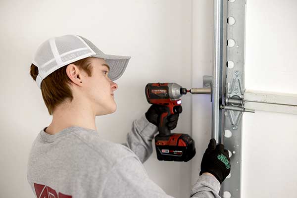 Garage Door Being Repaired By Technician